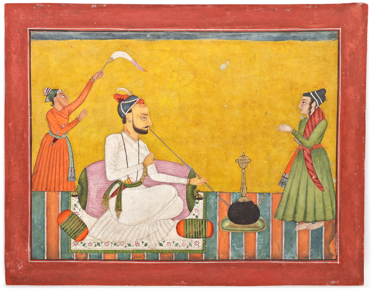 RAJA ANAND DEV OF BAHU SEATED SMOKING A HUQQA, WITH TWO ATTENDANTS ...