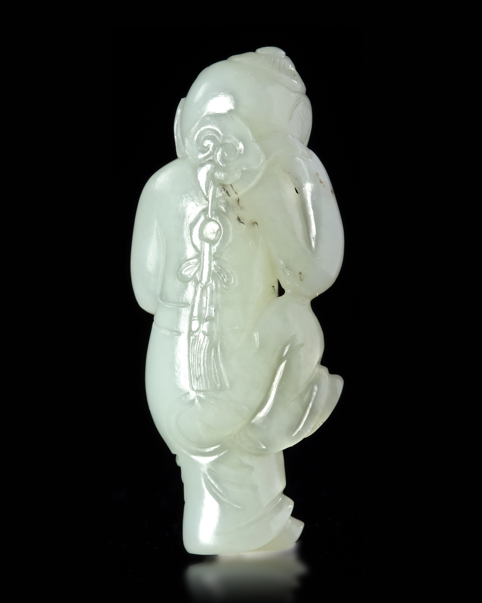 A CHINESE JADE CARVED FIGURE