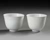 A  PAIR OF SMALL CHINESE WHITE-GLAZED PHOENIX CUPS, 20TH CENTURY