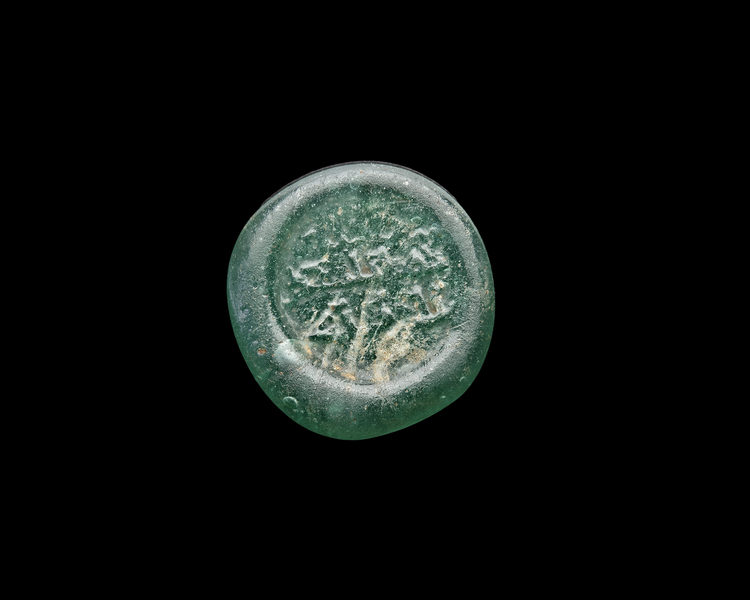 AN EARLY ISLAMIC GLASS WEIGHT OF HALF DIRHAM