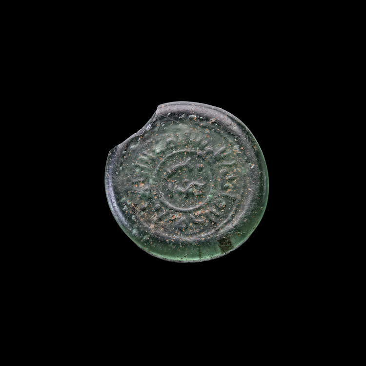 AN EARLY ISLAMIC GLASS WEIGHT OF DIRHAM