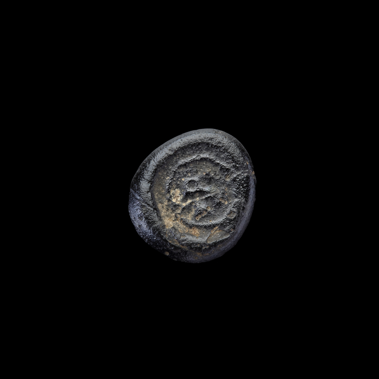 AN EARLY ISLAMIC GLASS WEIGHT OF QUARTER DINAR