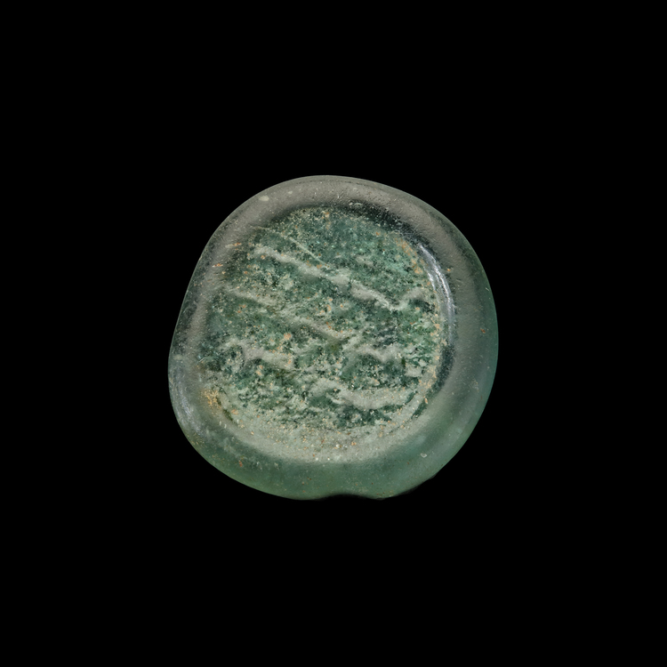 AN EARLY ISLAMIC GLASS WEIGHT OF DIRHAM