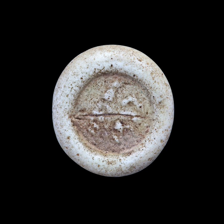 AN ABBASID GLASS WEIGHT OF DOUBLE DIRHAM, BAGHDAD AL-NASIR ( 576-622 AH/ 1080-1225 AD)