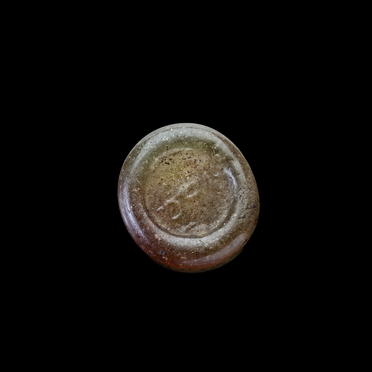 AN EARLY ISLAMIC GLASS WEIGHT OF QUARTER DINAR, 11TH-12TH CENTURY