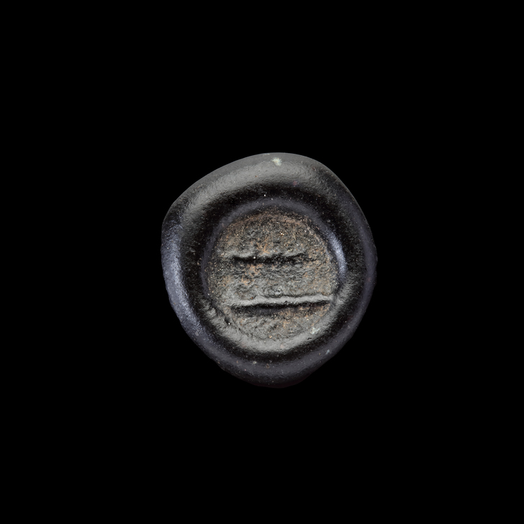 AN EARLY ISLAMIC GLASS WEIGHT OF HALF DIRHAM, 10TH-11TH CENTURY