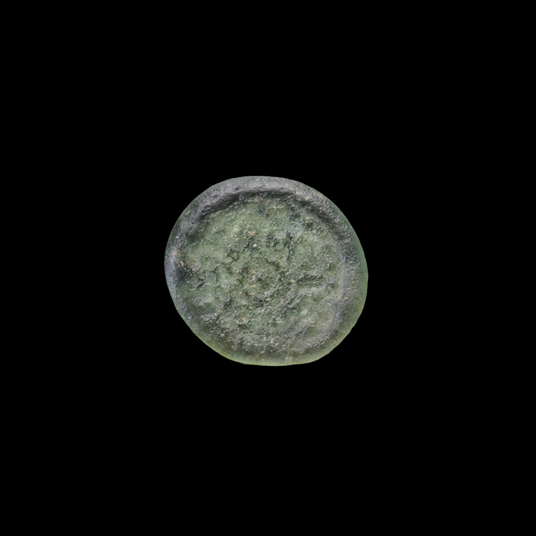 AN EARLY ISLAMIC GLASS WEIGHT OF QUARTER DIRHAM,10TH-11TH CENTURY