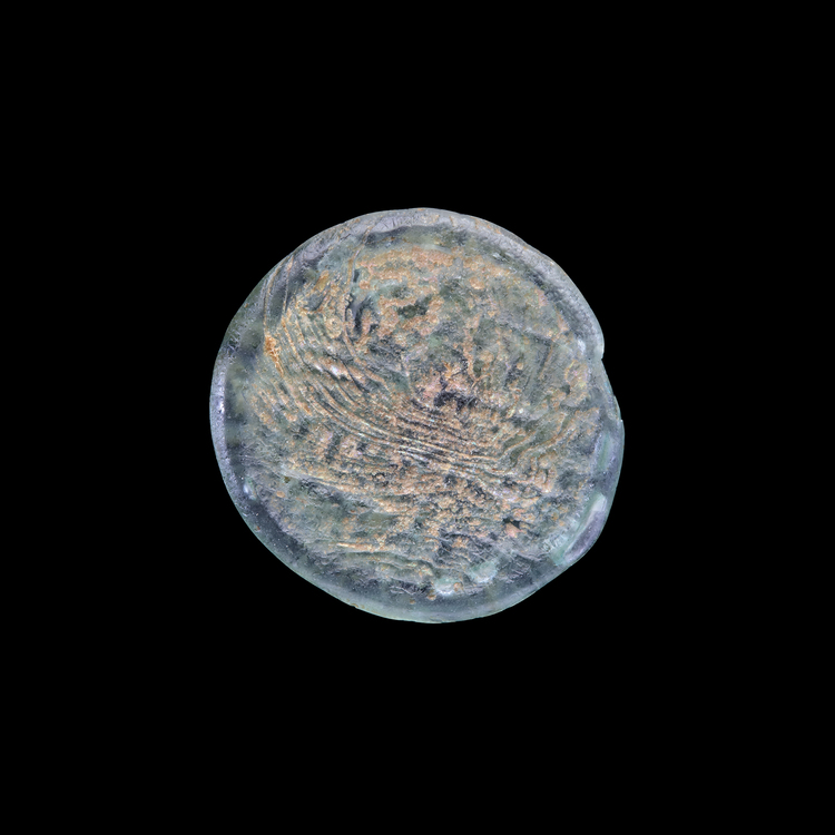 AN EARLY ISLAMIC GLASS WEIGHT OF HALF DIRHAM, 10TH-11TH CENTURY