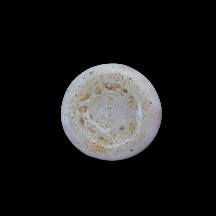 AN EARLY ISLAMIC GLASS WEIGHT OF HALF DIRHAM, 10TH-11TH CENTURY