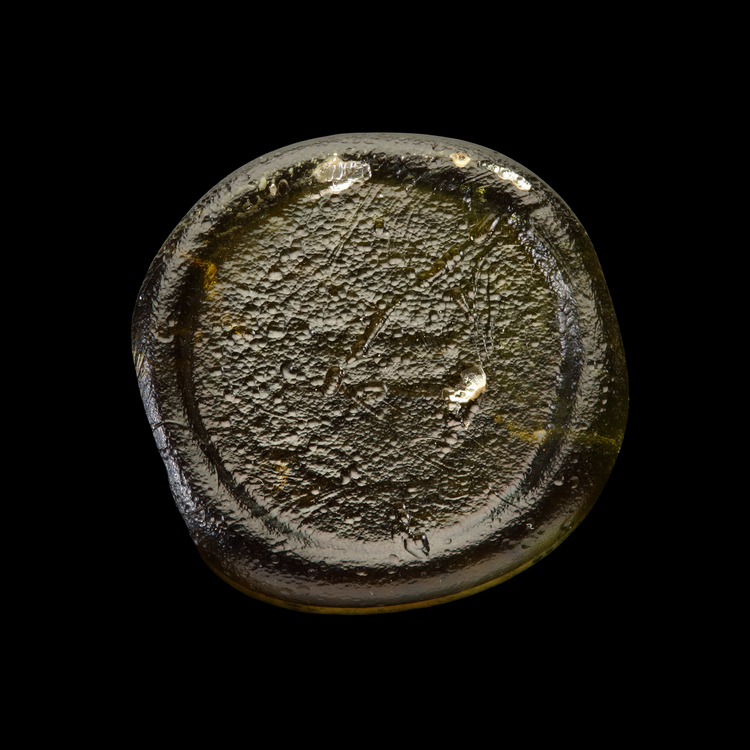 AN EARLY ISLAMIC GLASS WEIGHT OF DINAR, 10TH-11TH CENTURY