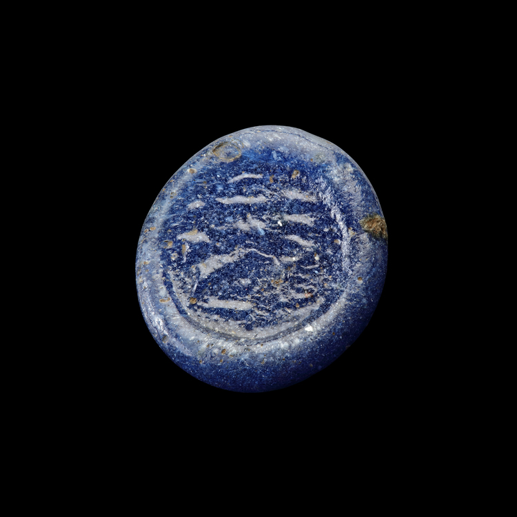 AN EARLY ISLAMIC GLASS WEIGHT OF HALF DIRHAM, 10TH-11TH CENTURY