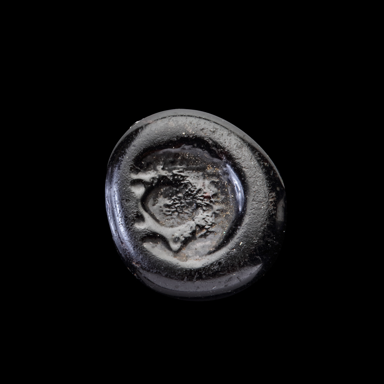 AN EARLY ISLAMIC GLASS WEIGHT OF HALF DIRHAM, 10TH-11TH CENTURY