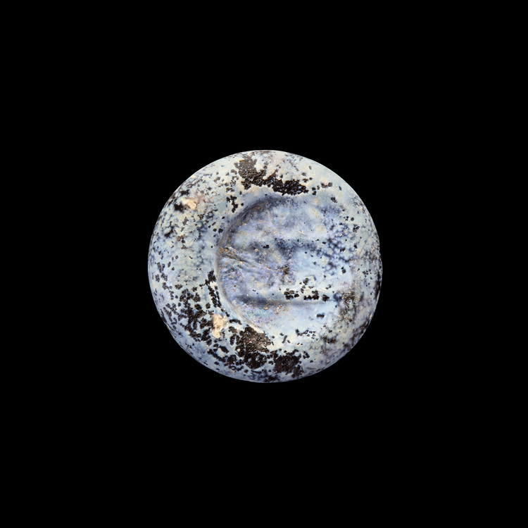 AN EARLY ISLAMIC GLASS WEIGHT OF HALF DIRHAM, 10TH-11TH CENTURY