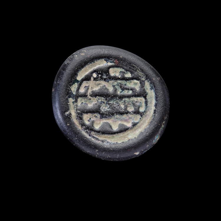 AN EARLY ISLAMIC GLASS WEIGHT OF DIRHAM, 10TH-11TH CENTURY