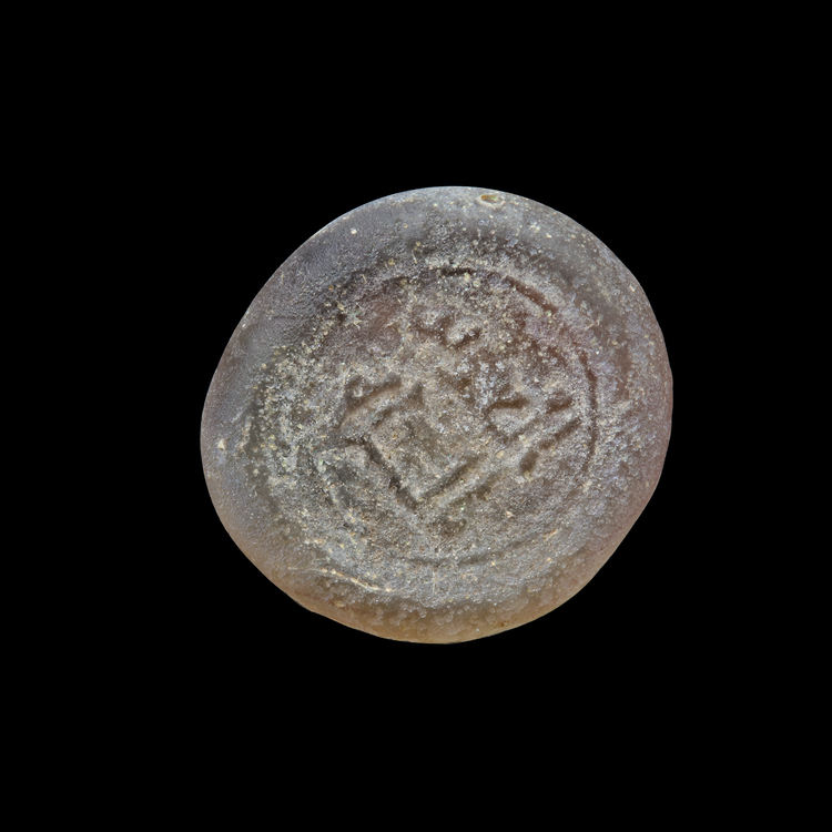 AN EARLY ISLAMIC GLASS WEIGHT OF DIRHAM