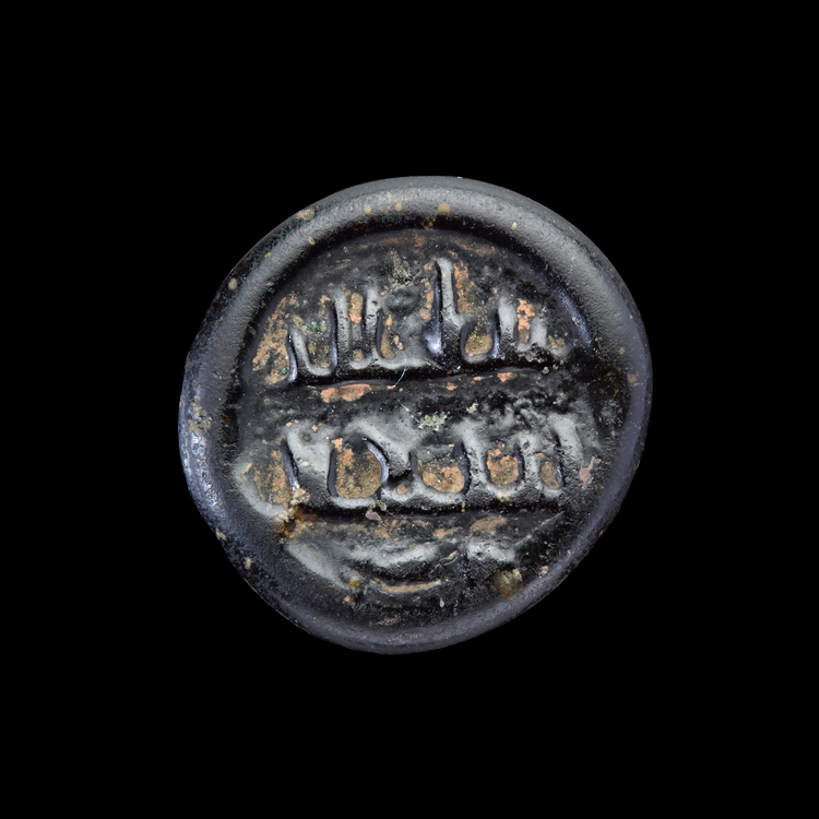 AN EARLY ISLAMIC GLASS WEIGHT OF DIRHAM, 10TH-11TH CENTURY
