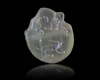A NEAR EASTERN SEAL IN GREEN CALCITE IN THE FORM OF A LION'S HEAD, 3RD MILLENNIUM BC