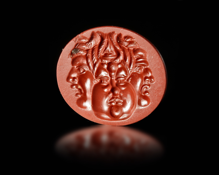 A RED JASPER INTAGLIO WITH A GRYLLOS WITH FOUR HEADS, ROMAN 1ST CENTURY AD