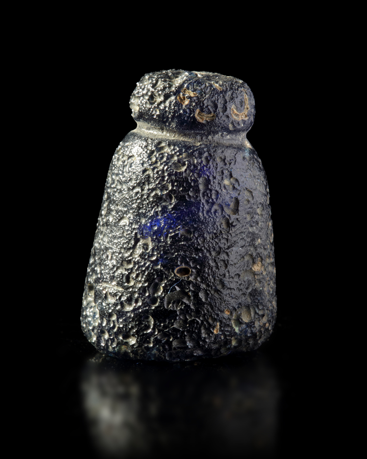 A CARVED GLASS CHESS PIECE, POSSIBLY A PAWN, 10TH-11TH CENTURY