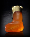 A CARNELIAN AMULET/SEAL IN THE SHAPE OF A LEG, PHOENICIAN, CIRCA 700 BC