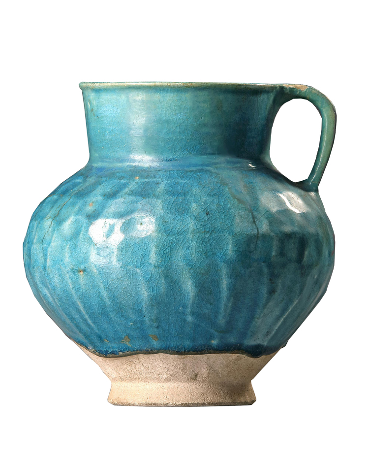 A TURQUOISE BLUE GLAZED POTTERY JUG, PERSIA-KASHAN, 12TH CENTURY