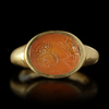 A ROMAN GOLD RING WITH A CARNELIAN INTAGLIO SHOWING THE HEAD OF AN EMPEROR, 4TH CENTURY AD