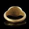 A ROMAN GOLD RING WITH A CARNELIAN INTAGLIO SHOWING THE HEAD OF AN EMPEROR, 4TH CENTURY AD