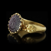 A BYZANTINE GOLD RING SET WITH A GARNET INTAGLIO, 6TH CENTURY AD OR LATER