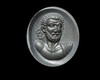A ROMAN INTAGLIO OF A FACING MAN IN BROWN GARNET, 1ST CENTURY AD