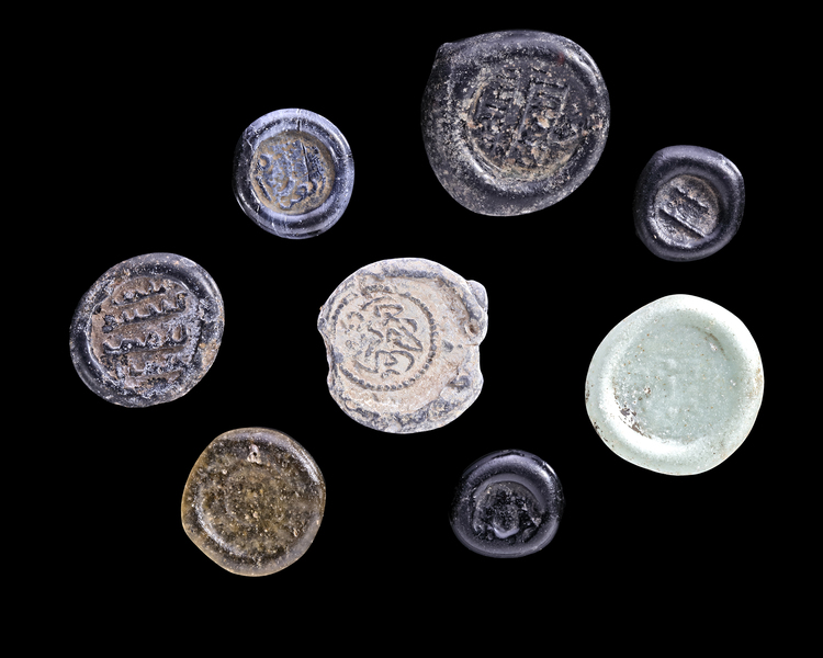 A GROUP OF EIGHT EARLY ISLAMIC GLASS WEIGHTS, 10TH-11TH CENTURY