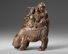 A CHINESE WOODEN CARVED BUDAI ON A BUDDHIST LION, 20TH CENTURY