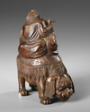 A CHINESE WOODEN CARVED BUDAI ON A BUDDHIST LION, 20TH CENTURY