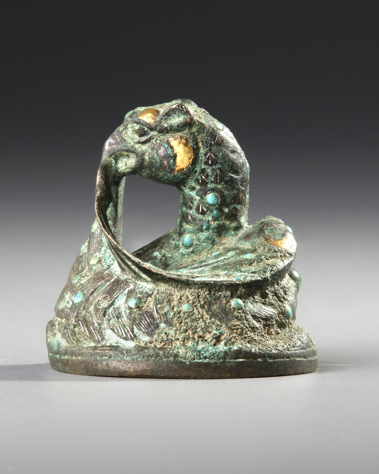 A CHINESE GOLD AND SILVER-INLAID BRONZE FIGURE OF A MYTHICAL BEAST WEIGHT, HAN DYNASTY (206 BC-AD 220) OR LATER