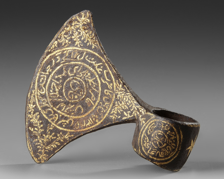 A PERSIAN GILT STEEL AXE HEAD, QAJAR DATED 1325 AH/1907 AD