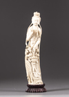 An ivory figure of a lady holding phoenix feathers