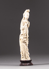 An ivory figure of a lady holding phoenix feathers