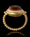 A LARGE ROMAN GOLD RING WITH AN INTAGLIO SHOWING A BUTTERFLY, 1ST CENTURY AD