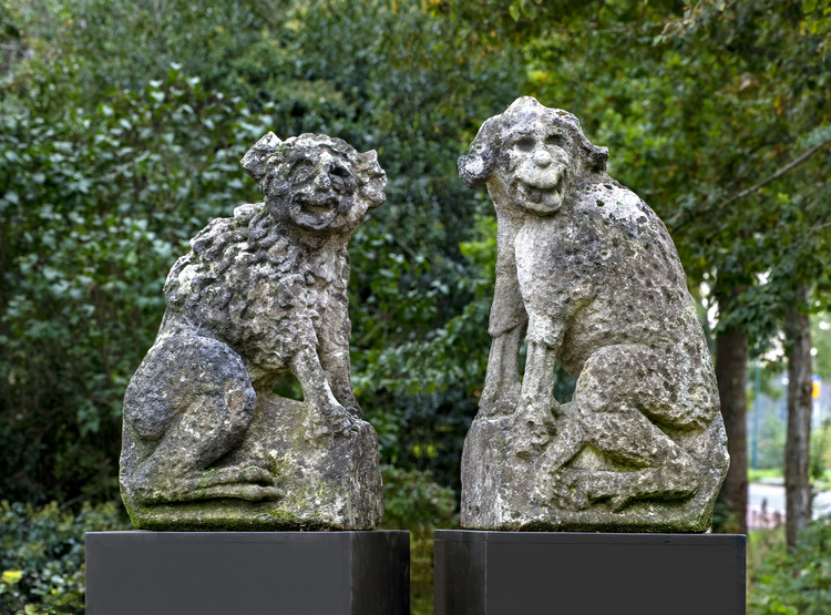 A PAIR OF FRENCH SCULPTED LIMESTONE FIGURES OF WATCHDOGS, EARLY 18TH CENTURY