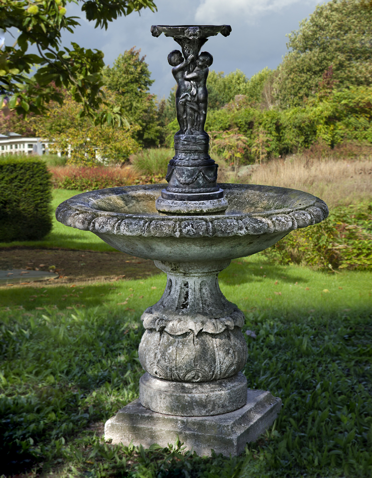 A CARVED LIMESTONE AND BRONZE MOUNTED FOUNTAIN, FIRST QUARTER 20TH CENTURY AND LATER