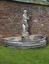 A COMPOSITE STONE AND WROUGHT IRON MOUNTED WALL FOUNTAIN COMPRISING ASSOCIATED, SECOND HALF 20TH CENTURY