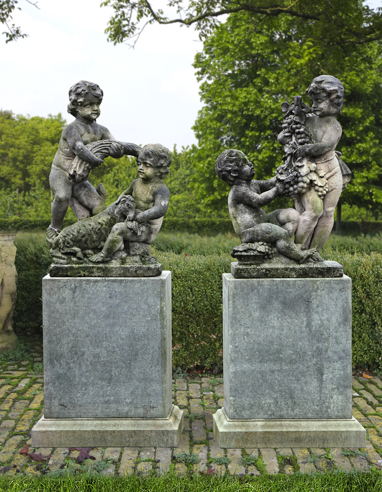 A PAIR OF SCULPTED LIMESTONE FIGURAL GROUPS OF PUTTI, LATE 19TH CENTURY