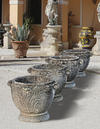 A SET OF FOUR COMPOSITION STONE GARDEN PLANTERS, LATE 20TH CENTURY