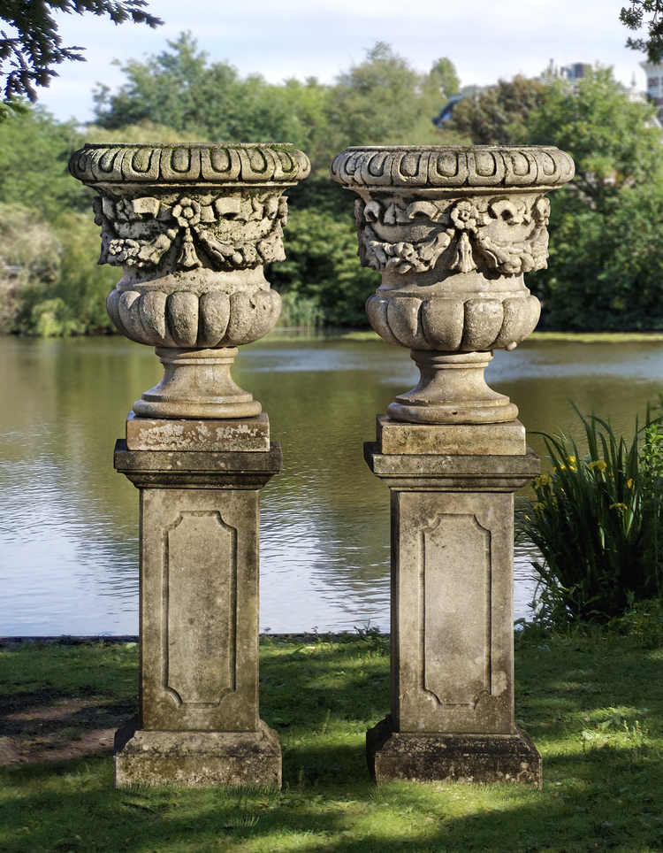 A PAIR OF CARVED LIMESTONE GARDEN URNS, LATE 19TH CENTURY