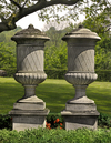 A PAIR OF SUBSTANTIAL CARVED LIMESTONE PEDESTAL URNS, SECOND HALF 20TH CENTURY