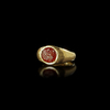 A HOLLOW ROMAN GOLD RING WITH A GARNET INTAGLIO OF AN EAGLE'S HEAD, 1ST CENTURY AD