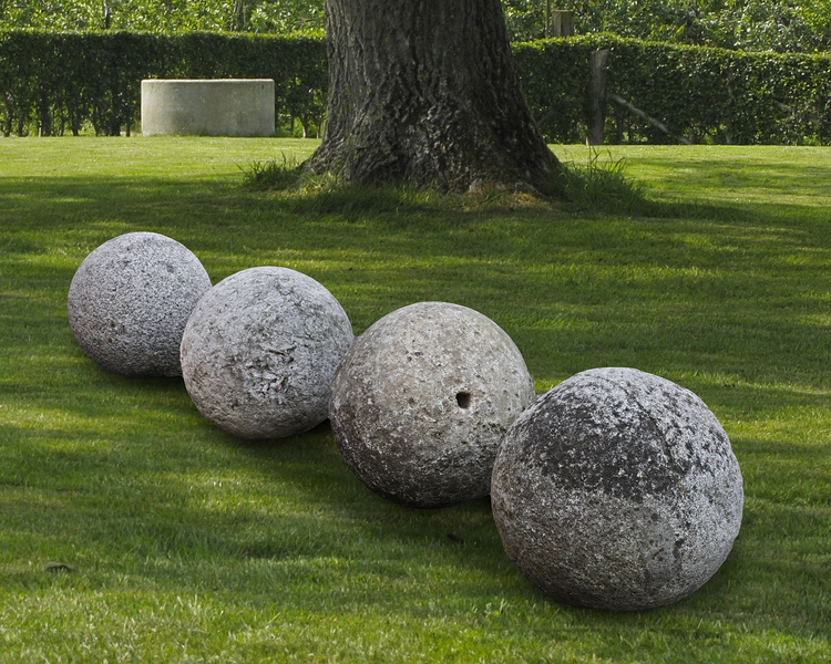A GROUP OF FOUR CARVED STONE ORNAMENTAL SPHERES, LATE 18TH CENTURY