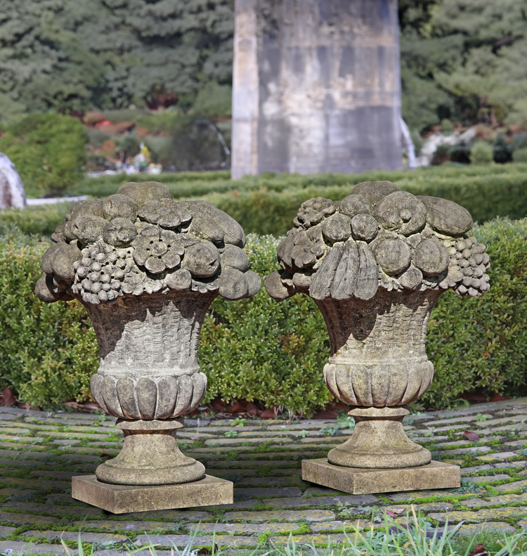 A PAIR OF LIMESTONE PIER FINIALS  IN THE FORM OF FLOWER/FRUIT BASKETS, 20TH CENTURY