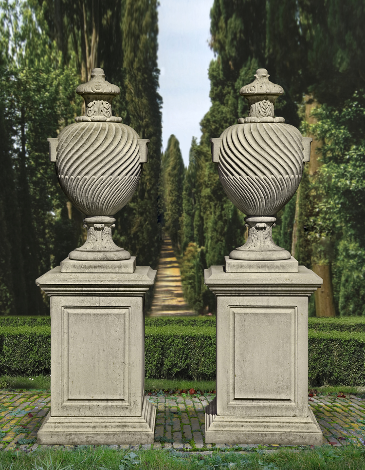 A PAIR OF CARVED LIMESTONE URNS ON PEDESTALS, LATE 20TH CENTURY, AFTER THE DESIGN BY WILLIAM KENT