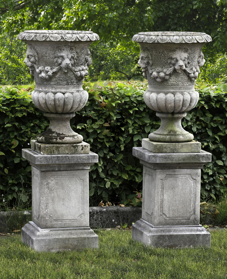 TWO SIMILAR CARVED LIMESTONE GARDEN URNS, LATE 19TH OR EARLY 20TH CENTURY