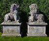 A PAIR OF SCULPTED LIMESTONE MODELS OF LIONS ON PEDESTALS, SECOND HALF 20TH CENTURY